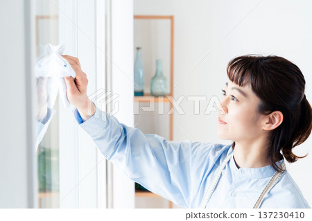 Woman cleaning the window Woman cleaning the window 137230410