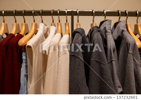 Pairs of clothes on hangers. Two identical items in wardrobe. Buying favorite items twice. Wardrobe with a set of each item. Conveniently buying two items at once. Pairs of clothes in closet Pairs of clothes on hangers. Two identical items in wardrobe. Buying favorite items twice. Wardrobe with a set of each item. Conveniently buying two items at once. Pairs of clothes in closet 137232601