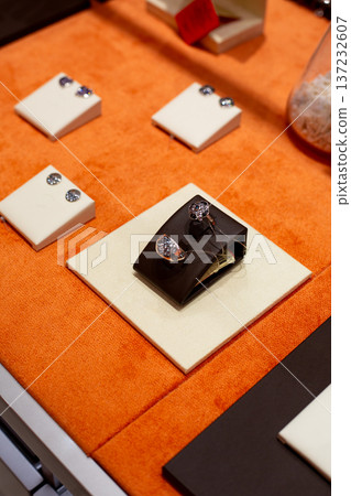 Nice little gift for girl while shopping, spontaneous purchase of new ring. Finger jewelry. Buying another ring for girl collection. Rings on jewelry store shelf Nice little gift for girl while shopping, spontaneous purchase of new ring. Finger jewelry. Buying another ring for girl collection. Rings on jewelry store shelf 137232607