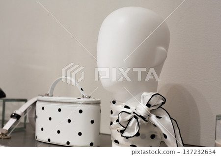 Timeless classic on store shelf. White with black dots on necktie and handbag. Combination of white and black polka dots. Dots on white textiles. Shopping in store with polka dot pattern Timeless classic on store shelf. White with black dots on necktie and handbag. Combination of white and black polka dots. Dots on white textiles. Shopping in store with polka dot pattern 137232634