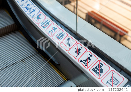 Escalator accidents. Dangers of moving structures on escalators. Possibility of things getting caught in cracks of escalator. Prevent injuries on escalators by following rules 137232641