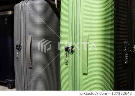Row of suitcases at airport in lost and found department. Items left behind and forgotten during flights. Searching for your suitcase with belongings. Losing suitcase while traveling 137232643