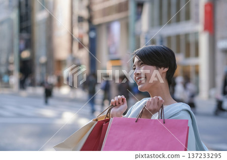 Profile of a smiling woman shopping in Ginza 137233295