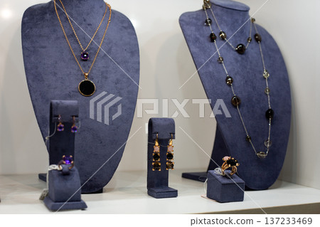 Set of custom jewelry for wealthy client. Precious pieces for special customer. Symbol of specialness and uniqueness in jewelry. Great love for unique accessories with jewelry on stand Set of custom jewelry for wealthy client. Precious pieces for special customer. Symbol of specialness and uniqueness in jewelry. Great love for unique accessories with jewelry on stand 137233469