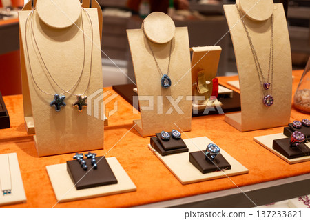 Array of elegant jewelry pieces on display at jewelry store. Unusual accessory silhouettes highlight elegance and current fashion. Trendy jewelry pieces showcase beauty and style Array of elegant jewelry pieces on display at jewelry store. Unusual accessory silhouettes highlight elegance and current fashion. Trendy jewelry pieces showcase beauty and style 137233821