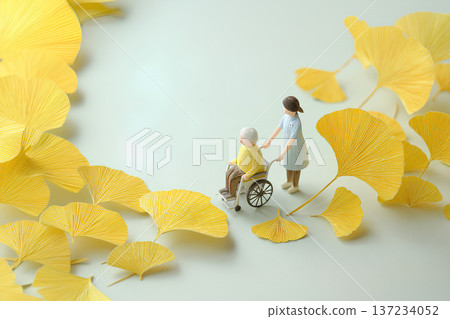 A gentle world of wheelchairs and caregivers surrounded by yellow ginkgo leaves 137234052
