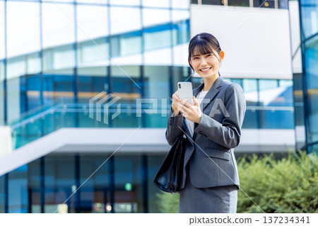 Business woman speaking on a smartphone Business woman speaking on a smartphone 137234341