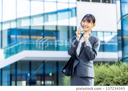 Business woman speaking on a smartphone Business woman speaking on a smartphone 137234343