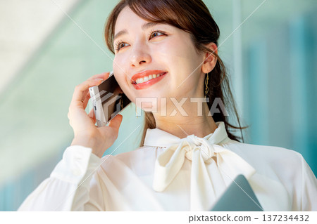 Woman talking on smartphone Business Woman talking on smartphone Business 137234432