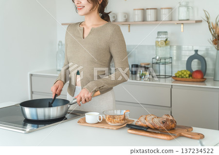 一位女士在廚房準備早餐。 137234522