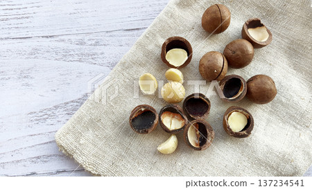 Macadamia nuts with a cutout on a canvas napkin. Healthy organic food Macadamia nuts with a cutout on a canvas napkin. Healthy organic food 137234541