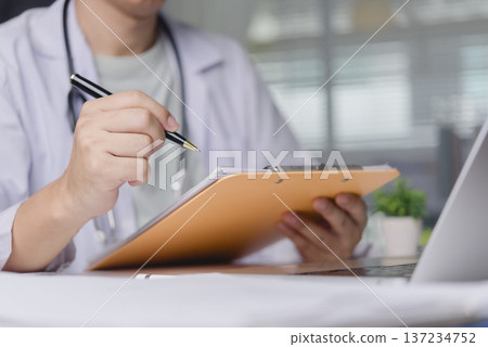 Doctor hand writing medical report on clipboard hospital office. Physician checking patient chart diagnosis using pen. Healthcare professional insurance prescription concept. Doctor hand writing medical report on clipboard hospital office. Physician checking patient chart diagnosis using pen. Healthcare professional insurance prescription concept. 137234752
