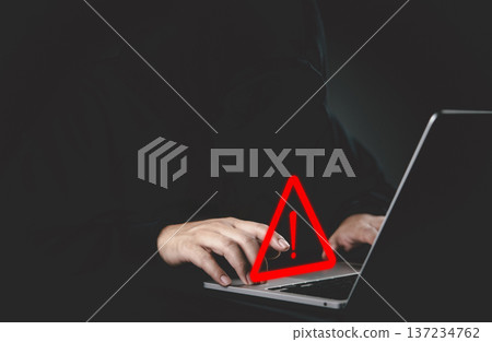 Hacker cyber security threat warning sign data breach privacy risk technology attack internet scam malware dark background computer laptop keyboard. 137234762