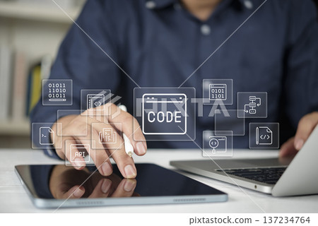 Programmer developer hands coding tablet laptop screen virtual icon api software web design technology html css binary data internet business application concept. 137234764