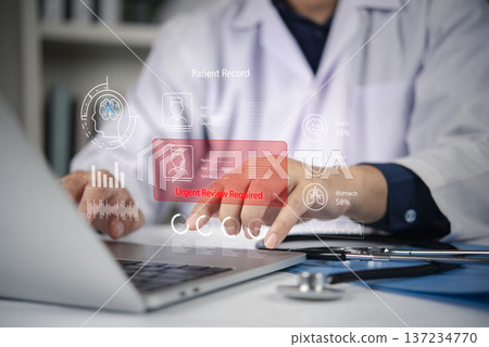 Doctor analyzing digital patient record on laptop screen, AI interface urgent review required data. Healthcare professional using technology for fast diagnostic, medical consultation in clinic. Doctor analyzing digital patient record on laptop screen, AI interface urgent review required data. Healthcare professional using technology for fast diagnostic, medical consultation in clinic. 137234770