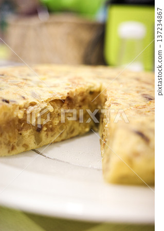Spanish potato omelette slice close up on white plate Spanish potato omelette slice close up on white plate 137234867