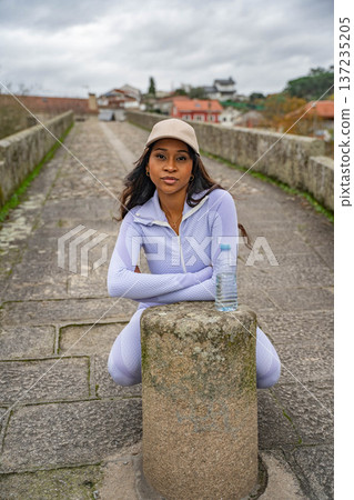 Woman Pauses Stone Bridge Woman Pauses Stone Bridge 137235205