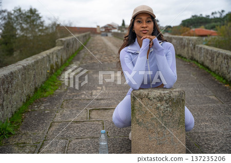 Woman Pauses Stone Bridge 137235206