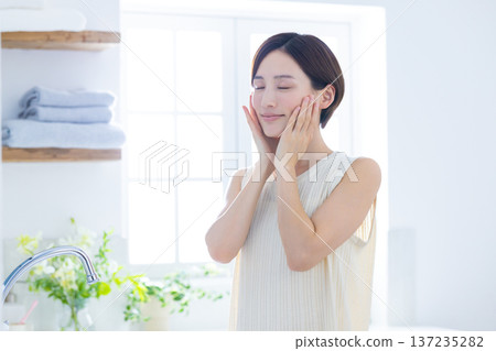 Beauty: A woman doing skin care in the bathroom 137235282