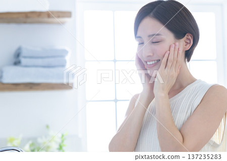 Beauty: A woman doing skin care in the bathroom Beauty: A woman doing skin care in the bathroom 137235283