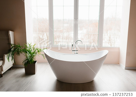 Luxury White Bathtub in Bright Minimalist Interior Luxury White Bathtub in Bright Minimalist Interior 137237253