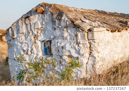 House old ruined adobe close-up, window and dry grass House old ruined adobe close-up, window and dry grass 137237267
