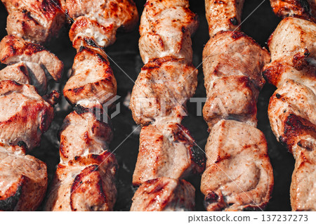 Fried meat in chunks, shish kebab on skewers, close-up, selective focus  137237273