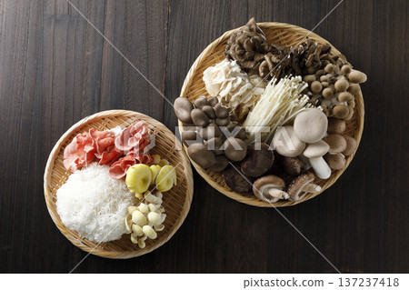 Various types of mushrooms in a colander on a wood grain background Various types of mushrooms in a colander on a wood grain background 137237418