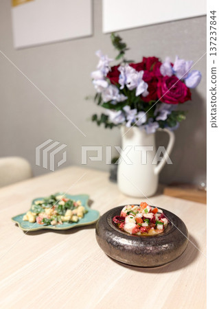 Stylish dining table and flowers Stylish dining table and flowers 137237844