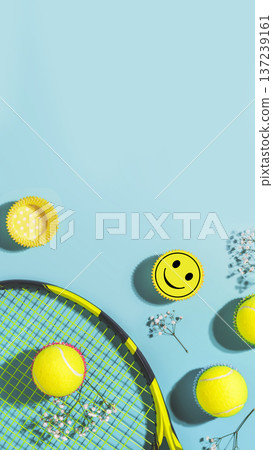 Tennis Racket With Yellow Balls And Smiley Sticker On Blue Background 137239161