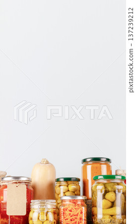 Homemade Pickled Vegetables In Glass Jars With Copy Space On Light Background 137239212