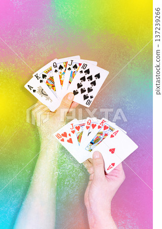 Playing Cards In Hands Against Vibrant Rainbow Gradient Background Playing Cards In Hands Against Vibrant Rainbow Gradient Background 137239266