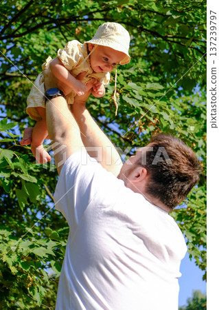 Father and Baby Enjoying a Sunny Day in the Park Father and Baby Enjoying a Sunny Day in the Park 137239797