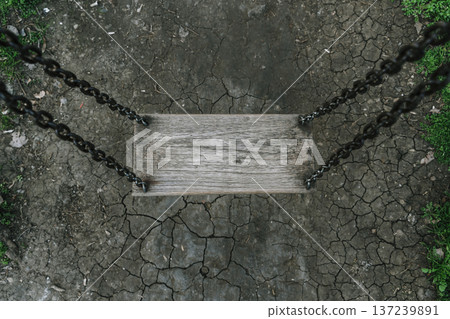 Lonely Wooden Swing Over Cracked Earth in Dark Melancholic Atmosphere Lonely Wooden Swing Over Cracked Earth in Dark Melancholic Atmosphere 137239891