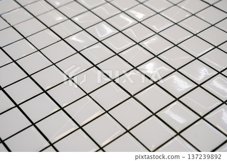 White ceramic tile background. Old vintage ceramic tiles in white to decorate the kitchen or bathroom White ceramic tile background. Old vintage ceramic tiles in white to decorate the kitchen or bathroom 137239892