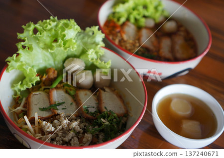 Traditional Sukhothai Tom Yum Rice Noodles with Sliced Long Beans, Red Pork, and Soft-Boiled Egg 137240671