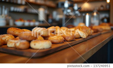 Baked goods are displayed in warm bakery setting where customers come to enjoy breakfast with fresh pastries and coffee 137240951