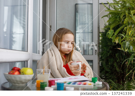 Young child relaxing and drinking tea or coffee after painting Young child relaxing and drinking tea or coffee after painting 137241339