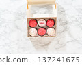 Flat lay. The birthday cupcakes, beautifully embellished with fondant decorations, are being carefully placed into white paper boxes, ready for their grand presentation. 137241675