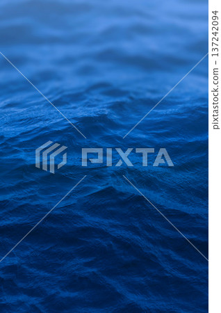 Blue water surface with soft waves. Blue ocean surface capturing the tranquil movement of the water Blue water surface with soft waves. Blue ocean surface capturing the tranquil movement of the water 137242094