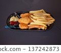 Golden Fried Chicken Nuggets and French Fries Served 137242873