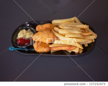 Golden Fried Chicken Nuggets and French Fries Served Golden Fried Chicken Nuggets and French Fries Served 137242873