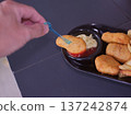 Hand Dipping Crispy Chicken Nugget into Tomato Ketchup 137242874
