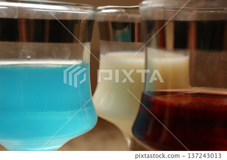 three glasses of colorful alcoholic beverages three glasses of colorful alcoholic beverages 137243013