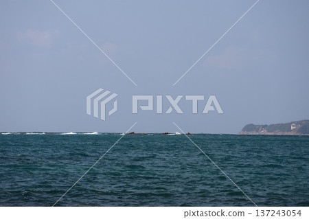 A landscape of blue sky, horizon, white waves, reefs, blue sea surface and cape A landscape of blue sky, horizon, white waves, reefs, blue sea surface and cape 137243054