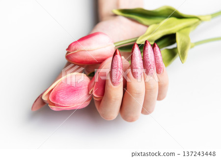 Woman's hand holding tulips with stiletto nails Woman's hand holding tulips with stiletto nails 137243448