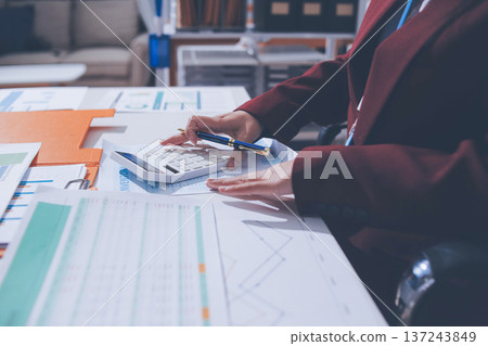 Accounting company provide finance and taxation planning for profitable cash flow, Auditor and accountant team working in office, analyze financial data and accounting record with calculator Accounting company provide finance and taxation planning for profitable cash flow, Auditor and accountant team working in office, analyze financial data and accounting record with calculator 137243849