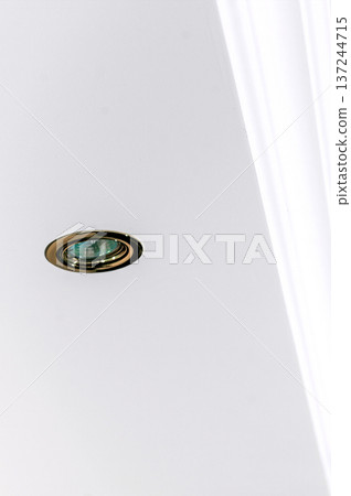 Decorative item made of white plaster on ceiling close-up. Relief stucco interior 137244715