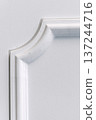 Decorative item made of white plaster on ceiling close-up. Relief stucco interior 137244716