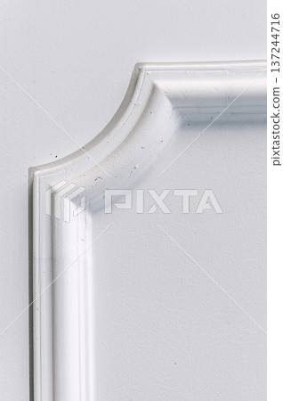 Decorative item made of white plaster on ceiling close-up. Relief stucco interior 137244716